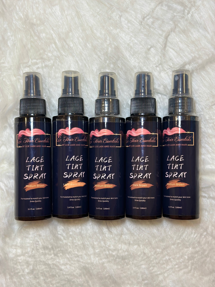 Five bottles of Lux Hair Essentials Lace Tint Spray in different shades displayed on a soft white background.