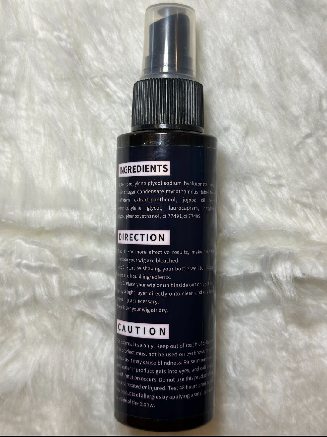 Back label of Lux Hair Essentials Lace Tint Spray bottle showing ingredients, directions, and caution instructions on a black background with white text.
