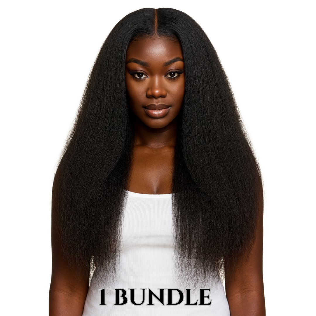 Smiling woman with long, voluminous  Lux lash and hair raw kinky straight black hair wearing a white top against a plain white background