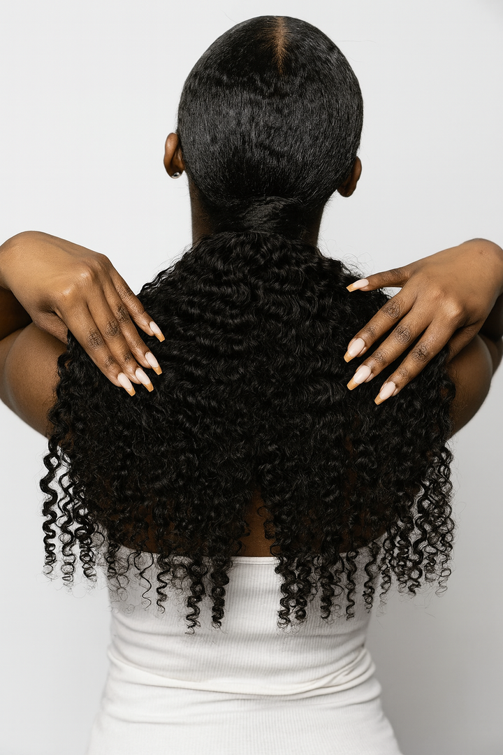 Back view of woman wearing Raw Burmese Curly Clip-In Ponytail extension, showing natural 3B–3C curls.