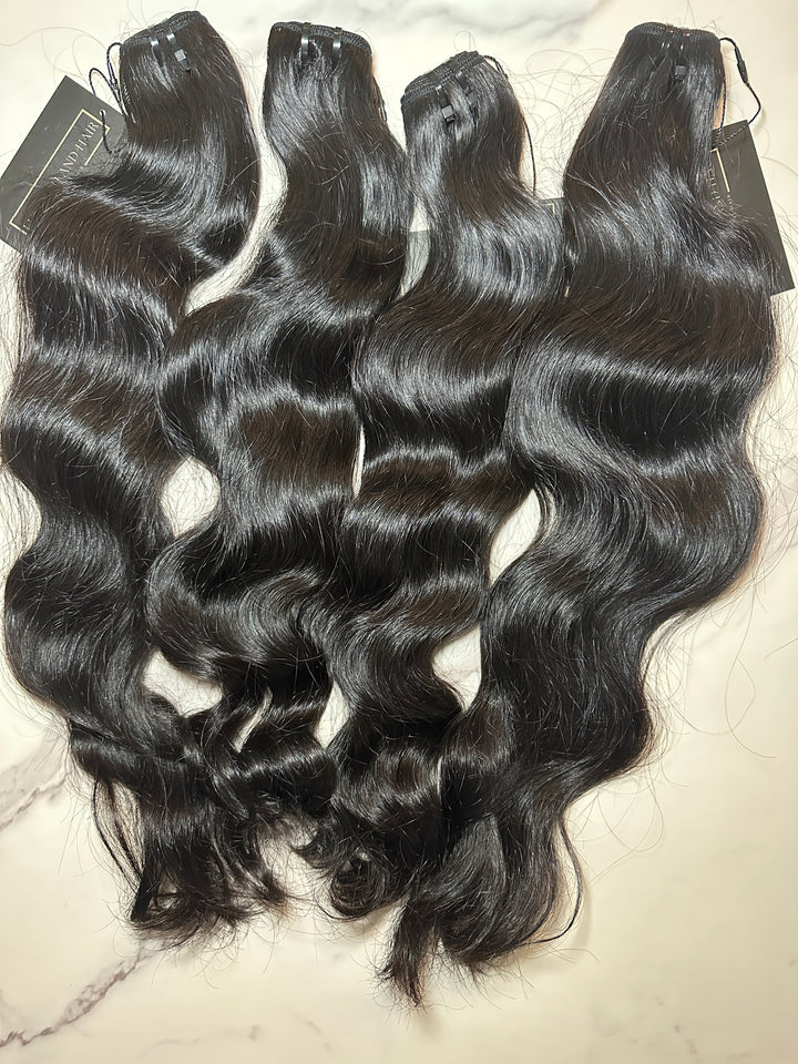 Four bundles of Lux Lash and Hair Raw Cambodian Natural Wave hair extensions, medium to dark brown, unprocessed and double drawn, displayed with brand tag.