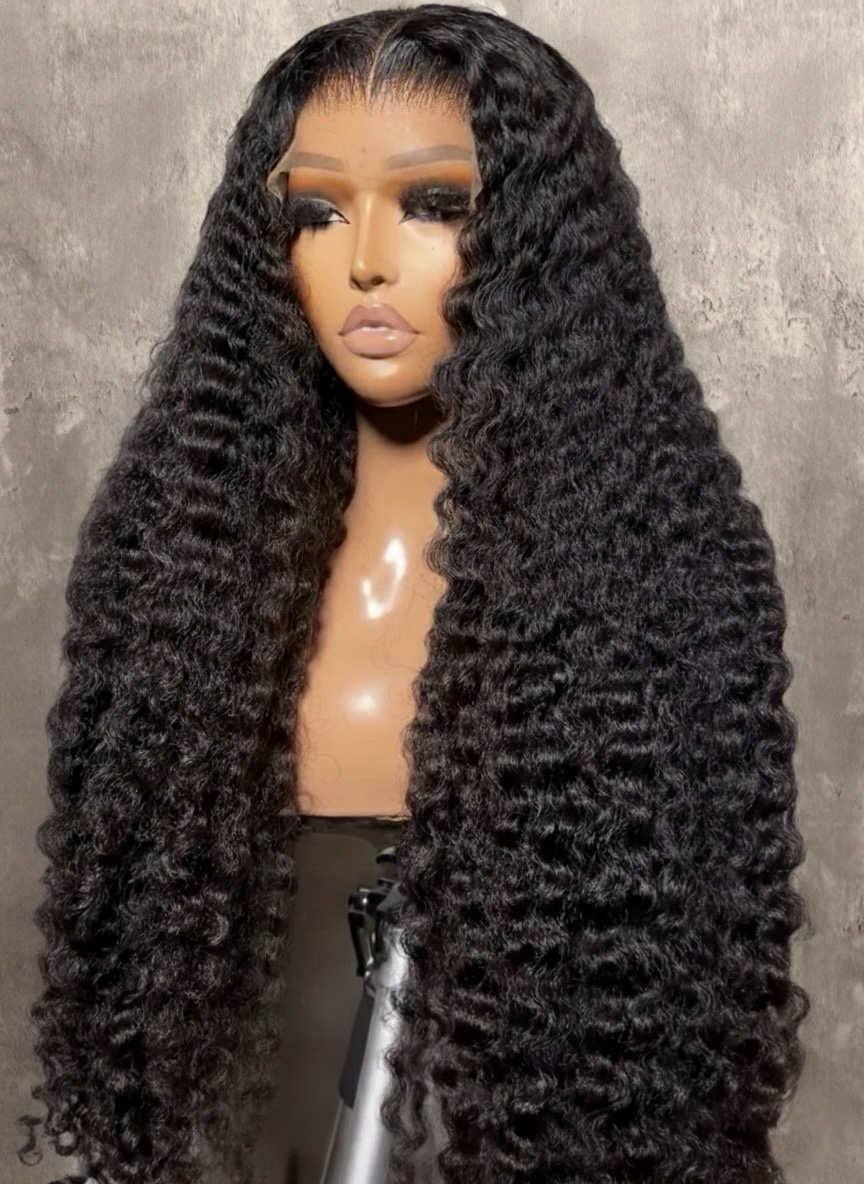 Raw Burmese curly human-hair wig with long, tight defined curls and HD lace front displayed on mannequin — Lux Lash and Hair.